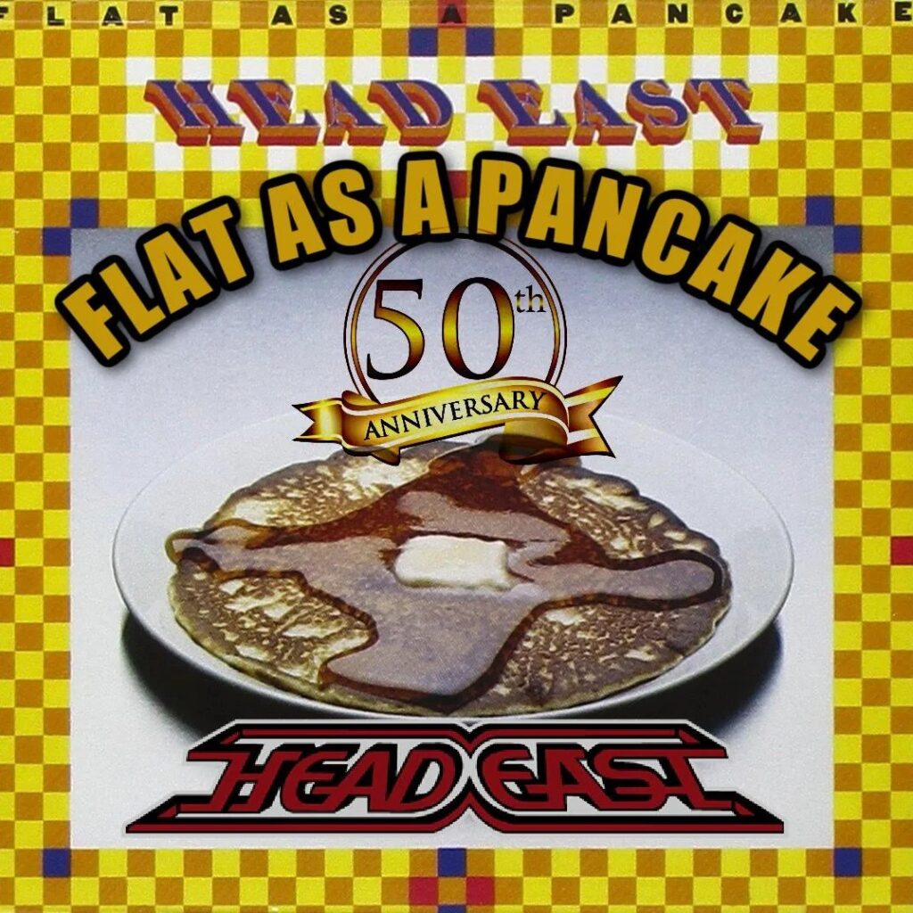 Head East album cover for 'Flat as a Pancake' 50th anniversary, showing a plate with a decorative pancake against a yellow checkerboard background.